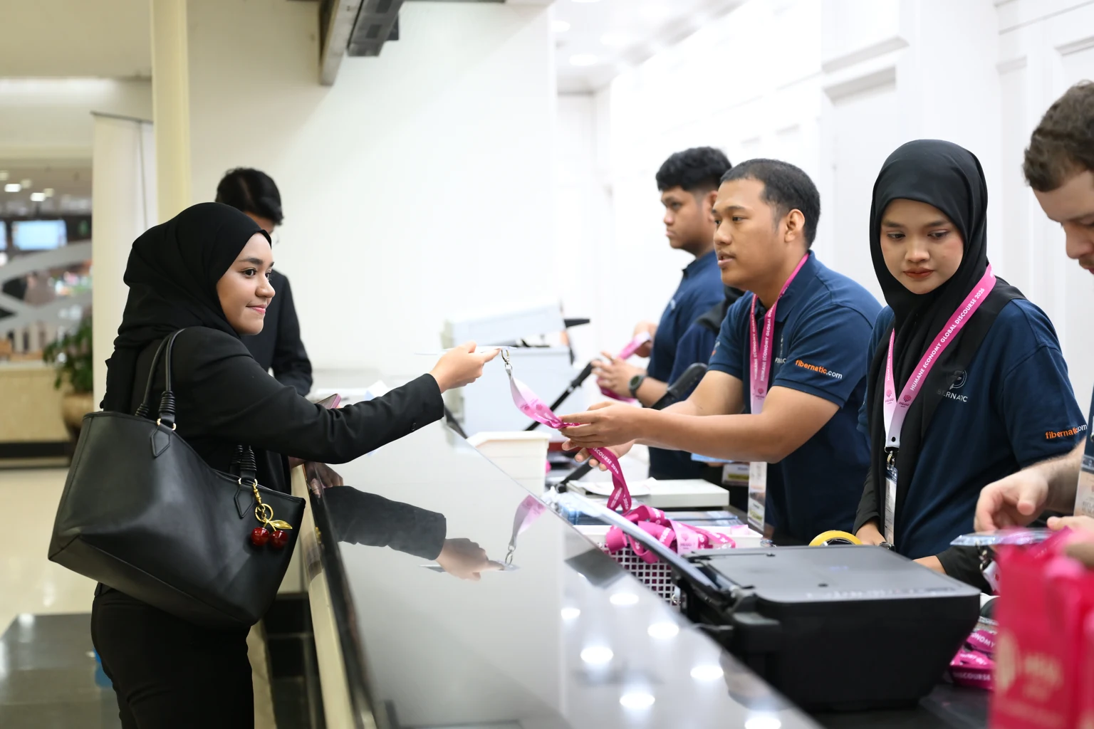 Fibernatic team assisting an attendee at the HEGD 2026 registration desk